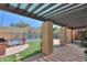 Covered outdoor patio with a built-in grill and a view of the sparkling swimming pool at 1131 N Cherry --, Mesa, AZ 85201