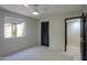 Bedroom featuring a ceiling fan, a window, and neutral carpeting at 1131 N Cherry --, Mesa, AZ 85201