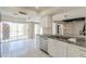 Bright kitchen featuring white cabinetry, granite countertops, stainless steel appliances, and sliding glass doors to the backyard at 1131 N Cherry --, Mesa, AZ 85201