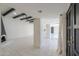 Spacious living area with a unique black fireplace, white tile flooring, and beamed ceilings at 1131 N Cherry --, Mesa, AZ 85201