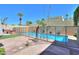 A large, fenced swimming pool surrounded by a decorative stone patio and tropical landscaping at 1131 N Cherry --, Mesa, AZ 85201