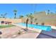 The backyard with a sparkling pool and charming desert landscaping is ideal for relaxation at 1131 N Cherry --, Mesa, AZ 85201