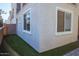 Backyard with faux grass and stucco exterior walls in neutral tones at 1183 S Tumbleweed Ln, Chandler, AZ 85286