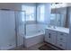 This bathroom features a glass-enclosed shower, large soaking tub, and lots of natural light at 1183 S Tumbleweed Ln, Chandler, AZ 85286