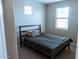 Neutral bedroom features a bed, two windows bringing ample of natural light at 1183 S Tumbleweed Ln, Chandler, AZ 85286