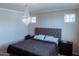 Bedroom features a chandelier, neutral walls, tufted headboard and carpet flooring at 1183 S Tumbleweed Ln, Chandler, AZ 85286