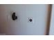 Interior wall of the garage showing an electrical outlet, switch, and black object at 1183 S Tumbleweed Ln, Chandler, AZ 85286