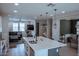 Spacious kitchen island with counter seating that connects to a living area with a television and stairs at 1183 S Tumbleweed Ln, Chandler, AZ 85286