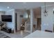 Living area with a staircase, television, and a view into a kitchen with an island and seating at 1183 S Tumbleweed Ln, Chandler, AZ 85286