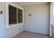 This patio features neutral colors, a large window, and an outdoor light fixture at 1183 S Tumbleweed Ln, Chandler, AZ 85286