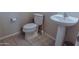 This powder room has a beige tile floor, a toilet, and a pedestal sink at 1183 S Tumbleweed Ln, Chandler, AZ 85286