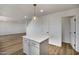 Bright kitchen features a white island with gray cabinets and pendant lighting at 1236 S Boulder St # C, Gilbert, AZ 85296