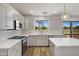 Bright kitchen features white cabinets, stainless steel appliances, and views to the backyard at 1236 S Boulder St # C, Gilbert, AZ 85296