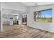Open living room with kitchen, neutral paint and sliding glass doors at 1236 S Boulder St # C, Gilbert, AZ 85296