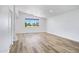 Bright living room featuring vaulted ceiling, hardwood floors, and large window at 1236 S Boulder St # C, Gilbert, AZ 85296