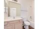 Bathroom boasts a single sink vanity, large mirror, toilet, and shower-tub combo at 125 N 22Nd Pl # 128, Mesa, AZ 85213