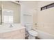 Bathroom featuring a single sink vanity, toilet, and tiled shower-tub combo at 125 N 22Nd Pl # 128, Mesa, AZ 85213