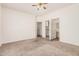 A spacious bedroom with neutral carpet and a ceiling fan is ready for furnishings at 125 N 22Nd Pl # 128, Mesa, AZ 85213