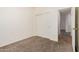 Bedroom featuring carpet, a closet, and doorways to other areas of the house at 125 N 22Nd Pl # 128, Mesa, AZ 85213