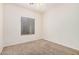 Bedroom features neutral carpet, a window with blinds, and ample lighting at 125 N 22Nd Pl # 128, Mesa, AZ 85213