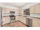Well-equipped kitchen featuring stainless steel appliances and tile flooring at 125 N 22Nd Pl # 128, Mesa, AZ 85213
