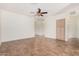 Spacious living room features tile flooring, a ceiling fan, and ample natural light at 125 N 22Nd Pl # 128, Mesa, AZ 85213