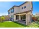 A well-maintained backyard features a plush artificial lawn, a brick patio, and a neutral colored two-story home at 1255 N Arizona Ave # 1013, Chandler, AZ 85225
