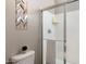 Bright bathroom featuring a glass-enclosed shower, white tile, and contemporary wall decor at 1255 N Arizona Ave # 1013, Chandler, AZ 85225