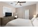 Comfortable bedroom featuring a large bed, dresser with a TV, and soothing neutral color palette at 1255 N Arizona Ave # 1013, Chandler, AZ 85225