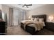 Cozy bedroom with a large bed, plush carpet, neutral tones, and ample natural light from the window at 1255 N Arizona Ave # 1013, Chandler, AZ 85225