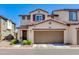 Charming two-story home featuring a two-car garage, manicured lawn and beautiful brown trim at 1255 N Arizona Ave # 1013, Chandler, AZ 85225