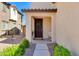 Inviting front entrance with a dark brown door with wreath, a 'hello' mat, and well-manicured bushes at 1255 N Arizona Ave # 1013, Chandler, AZ 85225
