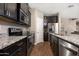 Modern kitchen features stainless steel appliances, dark cabinets, and granite countertops at 1255 N Arizona Ave # 1013, Chandler, AZ 85225