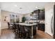 Modern kitchen featuring an island with granite countertops, stainless steel appliances, and dark wood cabinets at 1255 N Arizona Ave # 1013, Chandler, AZ 85225