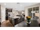 Open kitchen flows into the living area with stainless steel appliances, and an island with barstool seating at 1255 N Arizona Ave # 1013, Chandler, AZ 85225