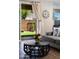 Cozy living room with elegant curtains, a large clock, and a view of the backyard at 1255 N Arizona Ave # 1013, Chandler, AZ 85225