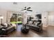 Open living room features hardwood floors, ceiling fan and a sliding glass door with access to the backyard at 1255 N Arizona Ave # 1013, Chandler, AZ 85225