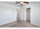Bedroom featuring carpet, ceiling fan, closet and door to bathroom at 12602 N 38Th Ave, Phoenix, AZ 85029