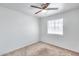 Bedroom with neutral carpeting, ceiling fan, and natural light from the window at 12602 N 38Th Ave, Phoenix, AZ 85029