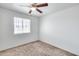 Bedroom with carpet, ceiling fan and window offering outside view at 12602 N 38Th Ave, Phoenix, AZ 85029