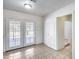 Dining area with access to the backyard through glass doors and tile flooring at 12602 N 38Th Ave, Phoenix, AZ 85029