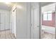 Hallway leading to bathroom with tile floors and neutral wall color at 12602 N 38Th Ave, Phoenix, AZ 85029