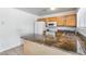 Functional kitchen showcasing wood cabinets, and an island with granite countertops at 12602 N 38Th Ave, Phoenix, AZ 85029