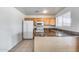 Bright kitchen with natural wood cabinets and a combination of granite and tile countertops at 12602 N 38Th Ave, Phoenix, AZ 85029