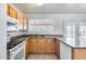 Bright kitchen featuring wood cabinets, a stainless steel sink, granite countertops, and modern appliances at 12602 N 38Th Ave, Phoenix, AZ 85029