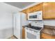 Close up featuring kitchen appliances, cabinets, and stylish granite countertops at 12602 N 38Th Ave, Phoenix, AZ 85029