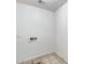 A simple laundry room featuring a utility sink and tiled flooring at 12602 N 38Th Ave, Phoenix, AZ 85029