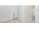 Simple white-walled laundry area with tile floors and hookups for a dryer at 12602 N 38Th Ave, Phoenix, AZ 85029