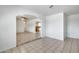 Bright living room featuring neutral tile floors and an archway to the kitchen at 12602 N 38Th Ave, Phoenix, AZ 85029