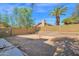 Empty backyard with a block wall, some trees, and a glimpse of the house at 12842 S Wakial Loop, Phoenix, AZ 85044